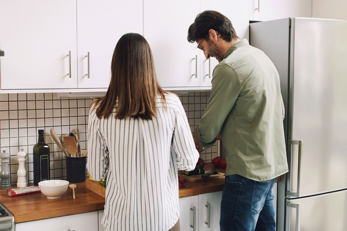 Man and women preparing food in the kitchen