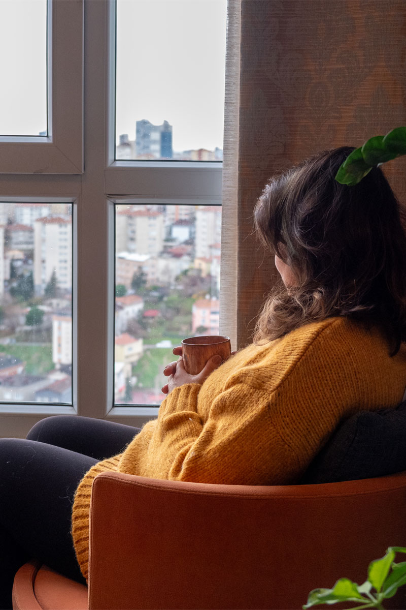 Women looking out of a window of a city below